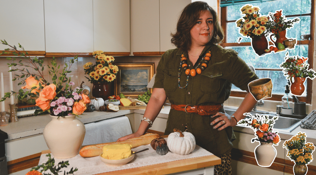 Woman in a cozy kitchen decorated with fall floral arrangements, bread, pumpkins, and handmade pottery for a rustic Thanksgiving. It is complemented with floral stickers of our arrangements.